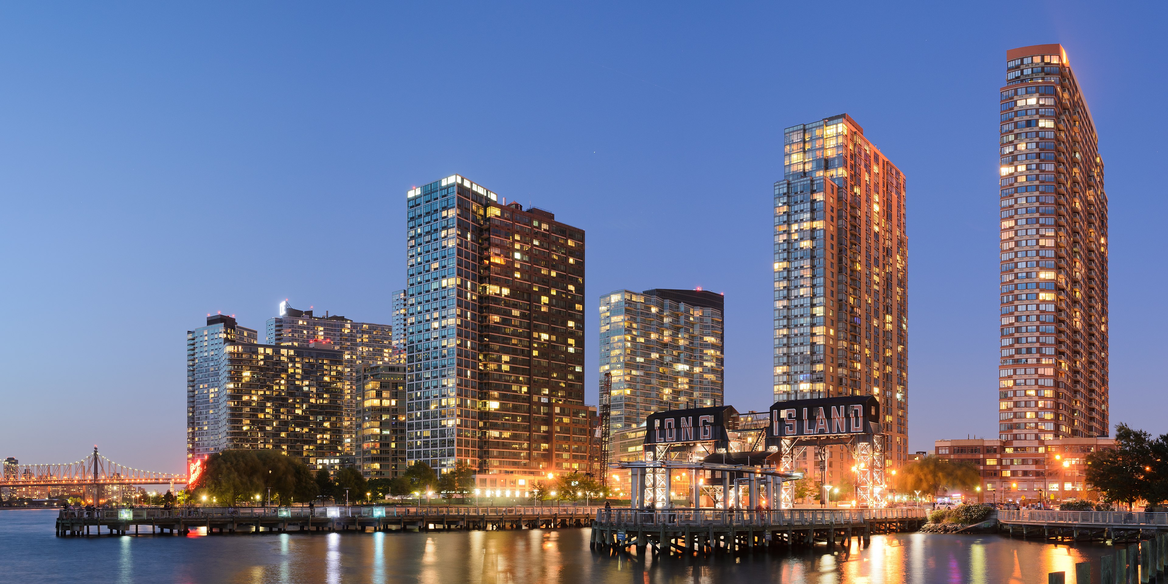 City skyline at dusk with lit towers